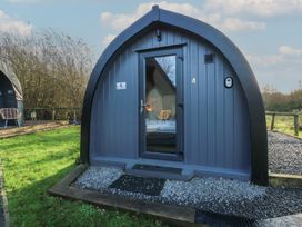 A cabin with a door and window in front at Garden Lodge 4 Swansea