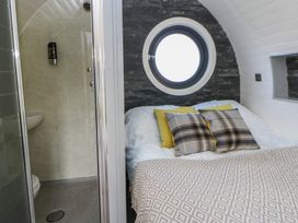 A bedroom with a bed and an adjoining bathroom at Garden Lodge 5 Swansea