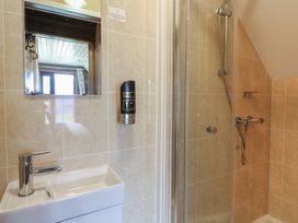A bathroom with a sink and shower at Garden Lodge 6 Swansea