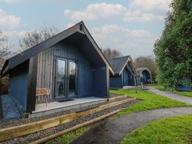 Cabins with porches in a nature setting at Garden Lodge 7 Swansea