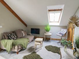 A living room with a sofa and coffee table at Rose Apartment in Oldwalls near Reynoldston