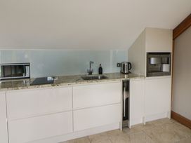 A kitchen with a sink and appliances at Rose Apartment Oldwalls near Reynoldston