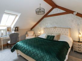 A bedroom with a bed and nightstands at Rose Apartment Oldwalls near Reynoldston