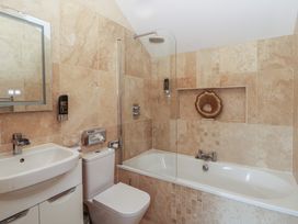 A bathroom with a sink and bathtub at Rose Apartment Oldwalls near Reynoldston