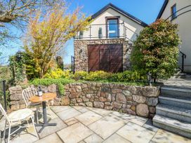 A garden with a table and chair at Rose Apartment, Old Walls, Llanrhidian, Gower