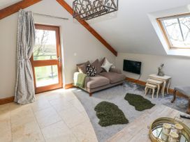 A living room with a sofa and a coffee table at Rose Apartment in Old Walls, Llanrhidian, Gower