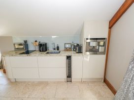 A kitchen with appliances and a countertop at Rose Apartment Old Walls, Llanrhidian, Gower