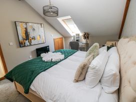 A bedroom with a bed and a desk in Rose Apartment Old Walls, Llanrhidian, Gower