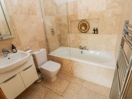 A bathroom with a bathtub, sink and toilet at Rose Apartment, Old Walls, Llanrhidian, Gower