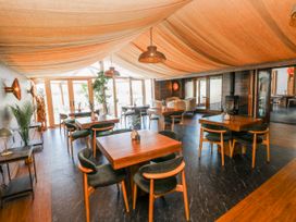 A dining room with tables and chairs at Rose Apartment in Old Walls, Llanrhidian, Gower