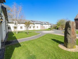 An outdoor area with buildings and a rock at Rose Apartment in Old Walls, Llanrhidian, Gower