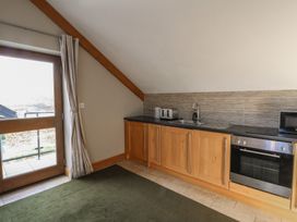 A kitchen with a sink and oven at Willow Apartment in Swansea
