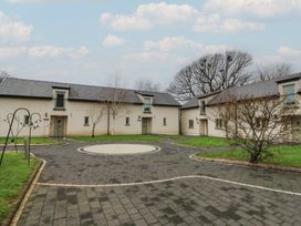 An outdoor view of buildings and pathway at Willow Apartment in Swansea