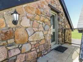 An exterior view showing a stone wall and a door at Willow Apartment in Oldwalls, Llanrhidian, Gower