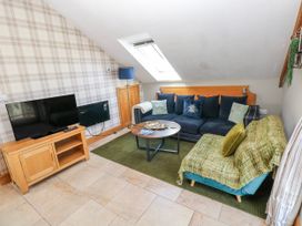 A living room with a sofa and coffee table at Willow Apartment Oldwalls, Llanrhidian, Gower