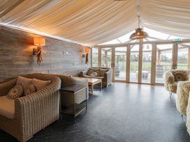 A snug area with seating and a coffee table at Ivy Cottage in Swansea
