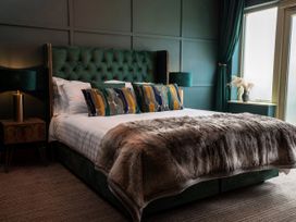 A bedroom with a bed and side table at Ivy Cottage Oldwalls near Reynoldston