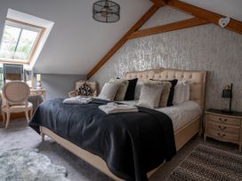 A bedroom with a bed and a desk at Ivy Cottage Oldwalls near Reynoldston