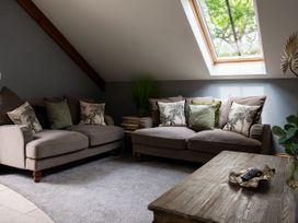 A living room with sofas and a skylight at Ivy Cottage Oldwalls near Reynoldston