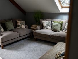 A snug room with two sofas and a coffee table at Ivy Cottage Oldwalls near Reynoldston