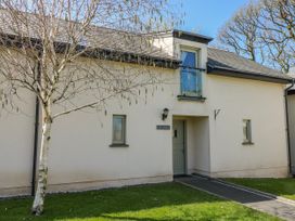 An exterior view of a building with a door and windows at Ivy Cottage in Oldwalls, Llanrhidian, Gower