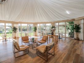A spacious room with seating and tables at Ivy Cottage Oldwalls, Llanrhidian, Gower
