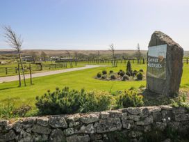 A sign displaying Gower Retreats in a landscaped area at Ivy Cottage Oldwalls, Llanrhidian, Gower