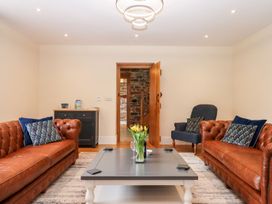 A living room with sofas and a coffee table at Knowle House in Okehampton