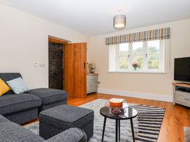 A living room with a sofa and coffee table at Knowle House in Okehampton