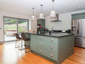 A kitchen with a large island and appliances at Knowle House Okehampton
