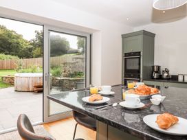 A kitchen with a dining table and croissants at Knowle House in Okehampton
