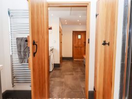 A laundry room with a washing machine and a towel rail at Knowle House in Okehampton