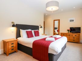 A bedroom with a bed and a television at Knowle House Okehampton