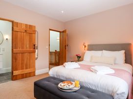 A bedroom with a double bed and breakfast tray at Knowle House Okehampton