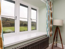 A room with windows overlooking a field at Knowle House in Okehampton