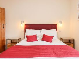 A bedroom with a bed and bedside tables at Knowle House Okehampton