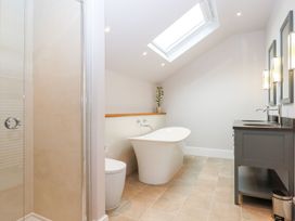 A bathroom with a bathtub, shower, toilet, and sink at Knowle House in Okehampton