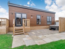 An outdoor area with a wooden exterior and steps at Pear Tree Spa Carlton Miniott near Thirsk