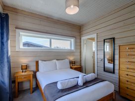 A bedroom with a bed and nightstand at Chestnut Spa (Pet) Carlton Miniott near Thirsk