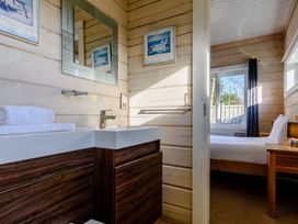 A bathroom with a sink and mirror at Chestnut Spa (Pet) Carlton Miniott near Thirsk