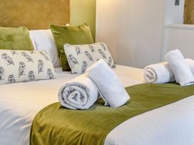 A bedroom with a bed, pillows, and towels at Pear Tree (Pet) Carlton Miniott near Thirsk