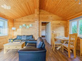 A living room with a sofa and dining table at Yew Tree Spa (Pet) Carlton Miniott near Thirsk