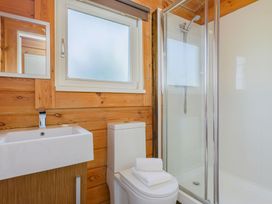 A bathroom with a sink and shower at Yew Tree Spa (Pet) Carlton Miniott near Thirsk