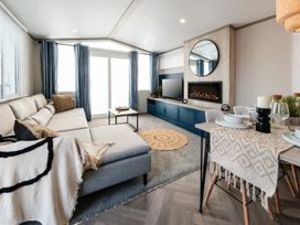 A living room with a sofa and coffee table at Rowan Waterside Spa, Carlton Miniott near Thirsk