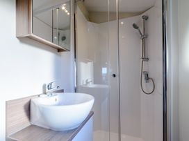 A bathroom with a sink and shower at Alder Waterside Spa Carlton Miniott near Thirsk