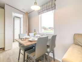 A dining room with a table and chairs at Cedar in Carlton Miniott near Thirsk