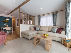 A living room with a sofa and coffee table at Ellery Waterside Spa Carlton Miniott near Thirsk