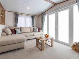 A living room with a sofa and coffee table at Ellery Waterside Spa Carlton Miniott near Thirsk