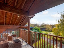 A balcony with seating overlooking garden at Birch Waterside Spa Carlton Miniott near Thirsk