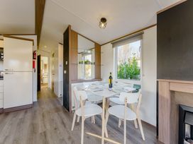 A dining room with a table and chairs at Spruce Waterside Spa in Carlton Miniott near Thirsk